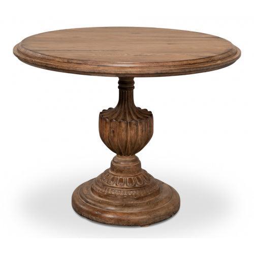Round wooden table with decorative pedestal base on a white background