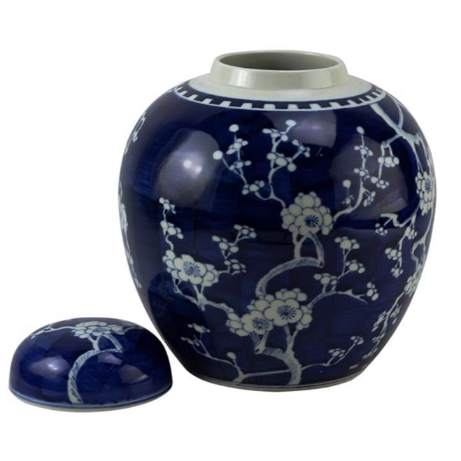 Blue ceramic jar with white floral patterns on a white background