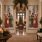 A large vertical wall tapestry banner featuring a vintage Christmas street scene with people singing in the snow, displayed on either side of a doorway in a beautifully decorated holiday living room with a Christmas tree and candles.