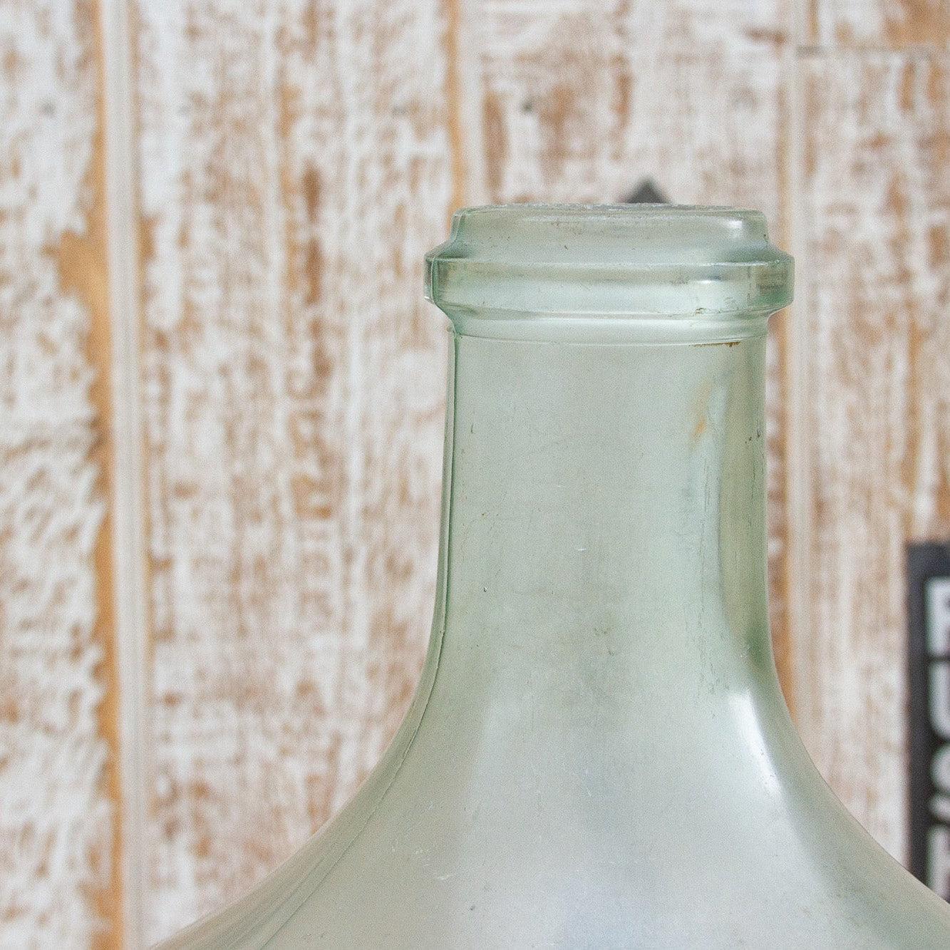 Clear glass bottle with a rustic wooden background