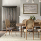 Dining room with wooden table and chairs, gray cabinet, and framed artwork on the wall.