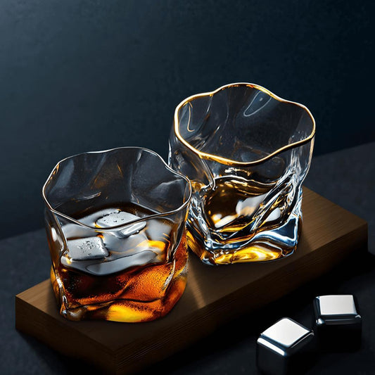 Two glass tumblers with a dark background