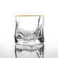 Clear glass with gold rim on a white background