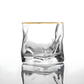Clear glass with gold rim on a white background