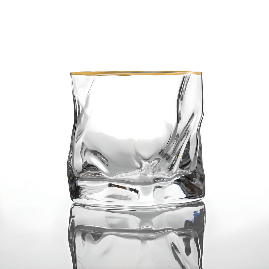 Clear glass with gold rim on a white background