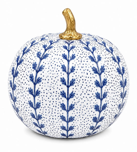 A decorative ceramic pumpkin with a white glaze, decorated with blue botanical leaf patterns and tiny blue dots, topped with a metallic gold stem, shown on a plain white background.
