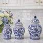 Set of three blue and white decorative jars on a kitchen counter with a bouquet of flowers.