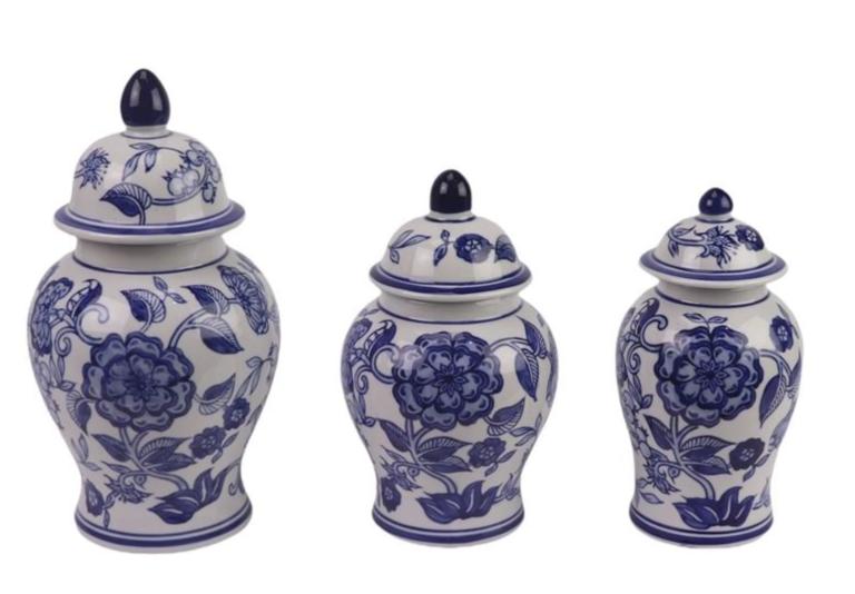 Set of three blue and white ceramic jars with floral designs on a white background