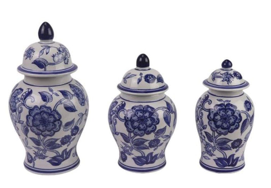 Set of three blue and white ceramic jars with floral designs on a white background